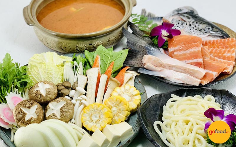 Bàn tiệc lẩu cá hồi kiểu Nhật với các loại hải sản tươi sống và rau nấm
